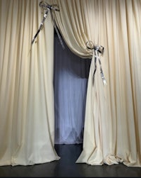 a curtain with a silver bow on it